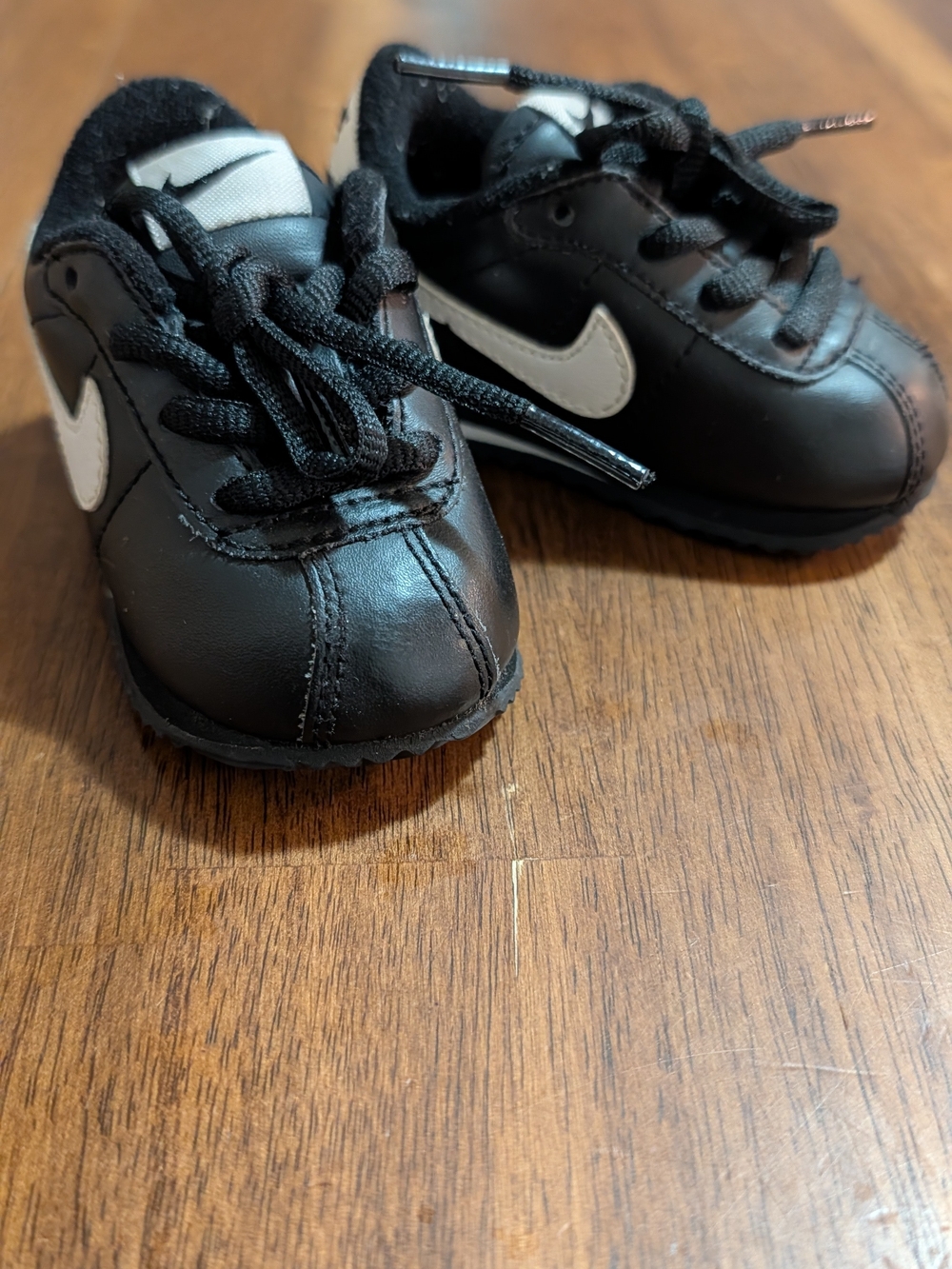 Nike Kids Black Sneakers with White Swoosh